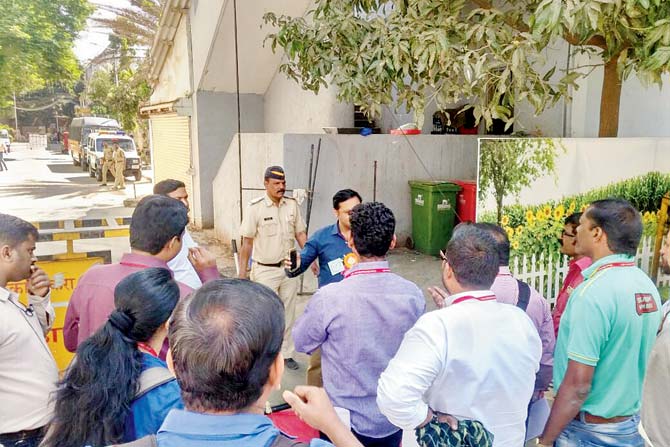Police and BMC officials try to pacify reporters and party workers outside the ASC