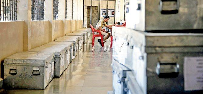 A cop keeps watch over EVMs at a counting centre yesterday. Pic/Shadab Khan