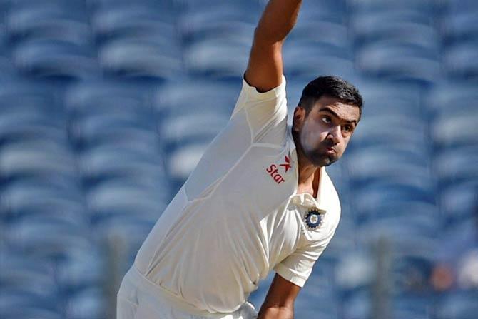 Indian bowler R Ashwin bowls on the opening day of the first test match played against Australia in Pune.Pic/ PTI 