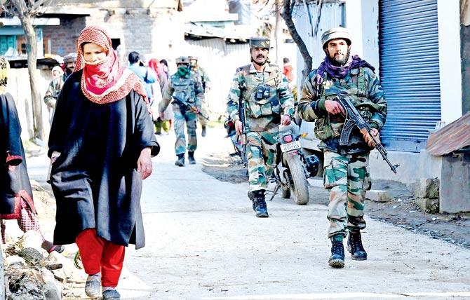 Army jawans patrol in Panjpora village of Bijbehara in south Kashmir, following the ambush in Shopian on Thursday. Pic/PTI