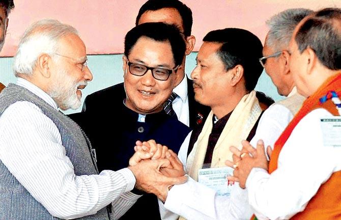 PM with BJP leaders at a rally in Imphal on Saturday. Pic/PTI