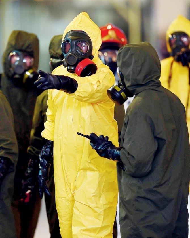Members of Malaysia’s Hazmat team conduct a decontamination operation. Pic/AFP