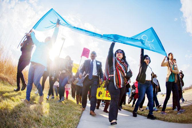 Members of the greater Kansas City community gather for a Peace March around the Ball Conference Center on Monday.