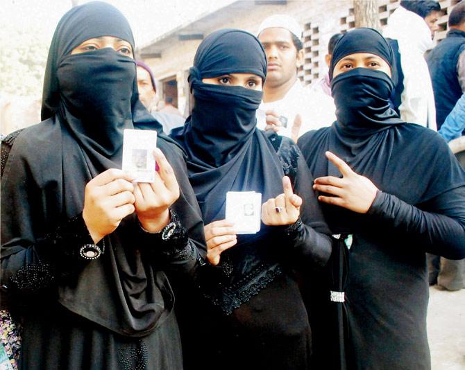 Voters show their ink-marked fingers after casting votes in the first phase at Ghaziabad. File Pic