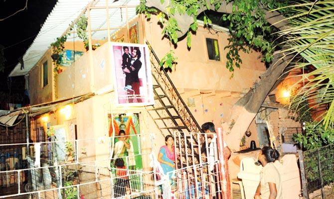 A poster of Dev Patel, Sunny hangs outside his house