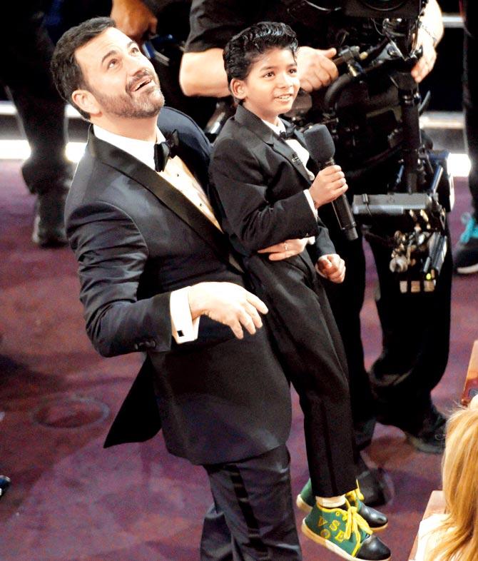 Jimmy Kimmel raises Sunny Pawar in the air at the Oscars