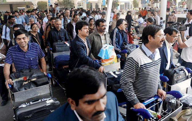 At the Mumbai Airport, around six immigration officers usually stamp the passports of approximately 10,000 people, resulting in long queues. Representation pic/AFP