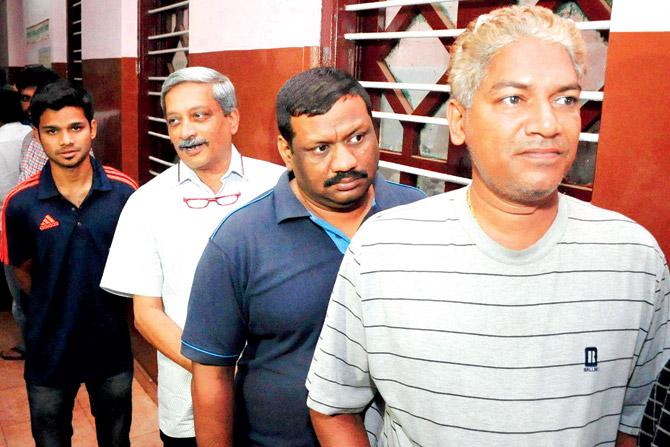 Manohar Parrikar in a queue at a polling booth in Goa. Pic/PTI