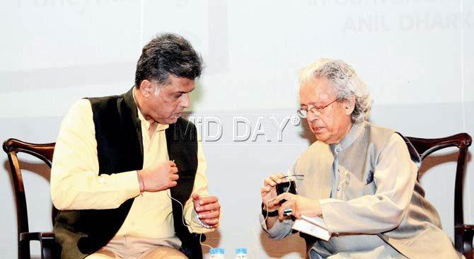Manish Tewari and Anil Dharker try to figure the working of their microphones at the release of the former’s book in Mumbai last evening. Pic/Bipin Kokate