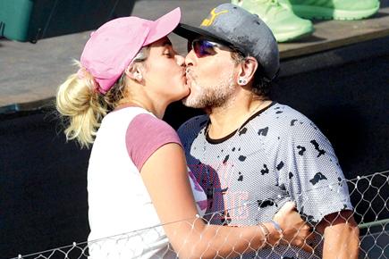 Diego Maradona spotted kissing fiance Rocio Oliva during Davis Cup match