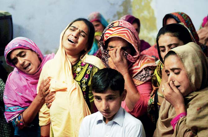 A Pakistani mother (second from left) mourns along with others over the coffin of her son, 13-year-old blast victim Zeeshan, during his funeral in the town of Sehwan in Sindh province. Pic/AFP