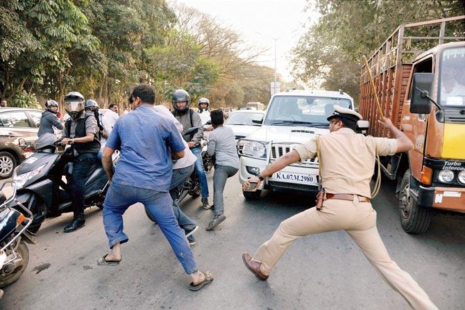 Police lathi-charge AIADMK supporters as Sasikala arrives. Pics/PTI