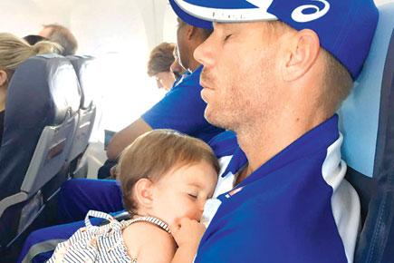 Aww! David Warner's one-year-old daughter takes a nap on daddy's lap