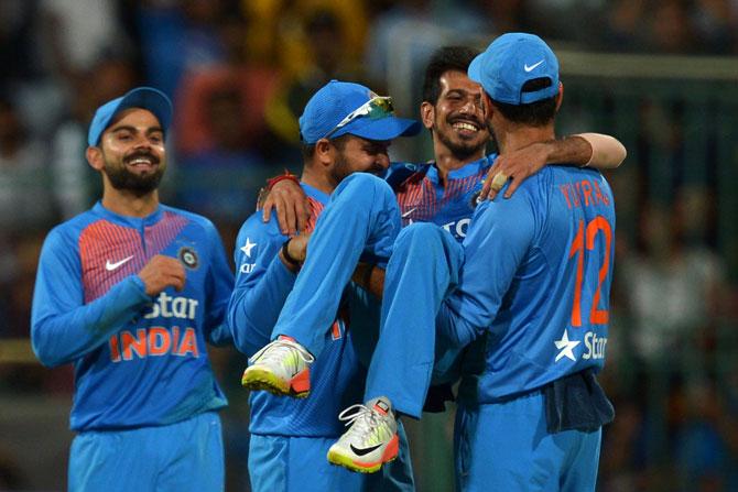 Indian bowler Yazvendra Chahal (2ndR) is lifted by his teammates for his six wicket haul against England during the third T20 cricket match between India and England at the Chinnaswamy Cricket Stadium in Bangalore on February 1, 2017. England is chasing a target of 203 runs scored by India. Pic/AFP