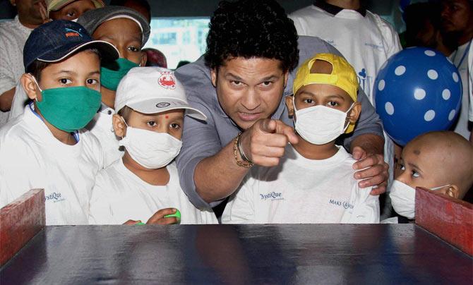Sachin Tendulkar having fun with children suffering from cancer at an event