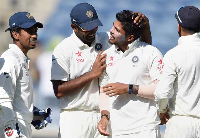 Umesh Yadav celebrates with teammates the wicket of Australian batsman Nathan Lyon during the first day of the first cricket test match in Pune on Thursday. Pic/PTI
