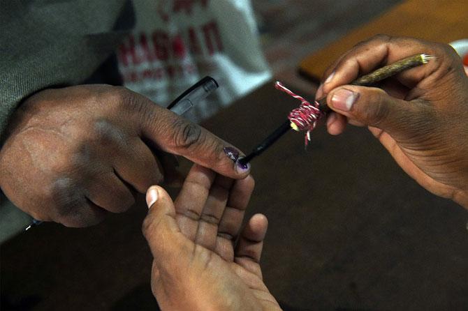 An Indian election officer marks the finger of a voter at a polling station in Muzaffarnagar in Uttar Pradesh on February 11, 2017. Voting got underway on February 11 in India