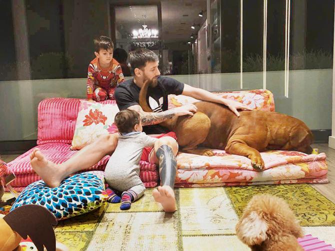 Antonella Roccuzzo posted this picture of Lionel Messi and sons Mateo (1) and Thiago (4) playing with their dog on Instagram