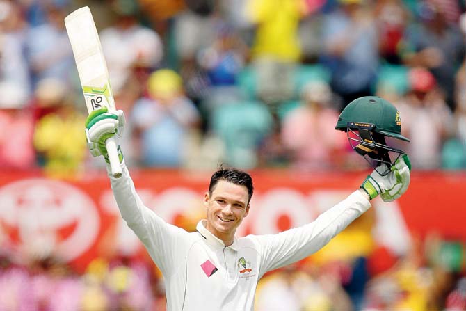Australia’s Peter Handscomb celebrates his century on Day Two of the third Test against Pakistan in Sydney this morning. Pics/Getty Images