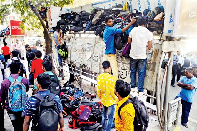 As bags were not allowed inside the Brabourne Stadium for the India A against England match yesterday, fans were seen piling up their bags on top of bus stops. Pic/Datta Kumbhar