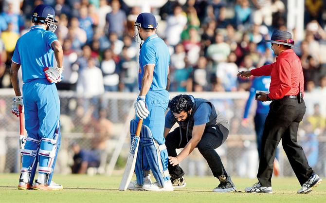 A fan touches India A skipper MSâÂÂu00c2u0080ÂÂu00c2u0088Dhoni’s feet during the match against England at CCI yesterday. Pic/Suresh Karkera