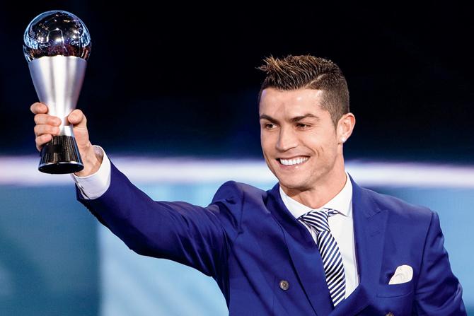 Portugal’s star footballer Cristiano Ronaldo poses with the FIFA Best Player award in Zurich, Switzerland on Monday. Pic/Getty Images