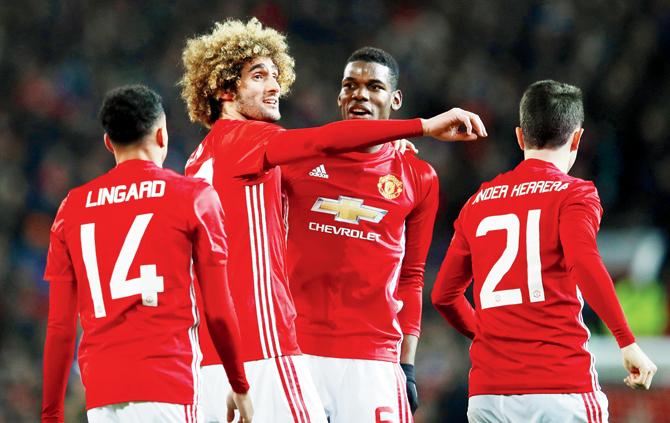 Man United’s Marouane Fellaini (second from left) celebrates his goal with teammates against Hull during the first leg of League Cup semi-final tie at Old Trafford in Manchester on Tuesday. Pic/Getty Images