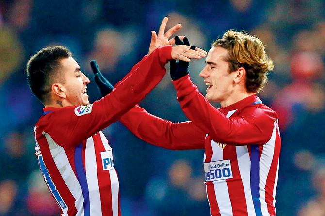 Atletico de Madrid’s Antoine Griezmann (right) celebrates scoring his second goal with teammate Angel Martin Correa during the Copa del Rey tie on Tuesday. Pic/Getty Images