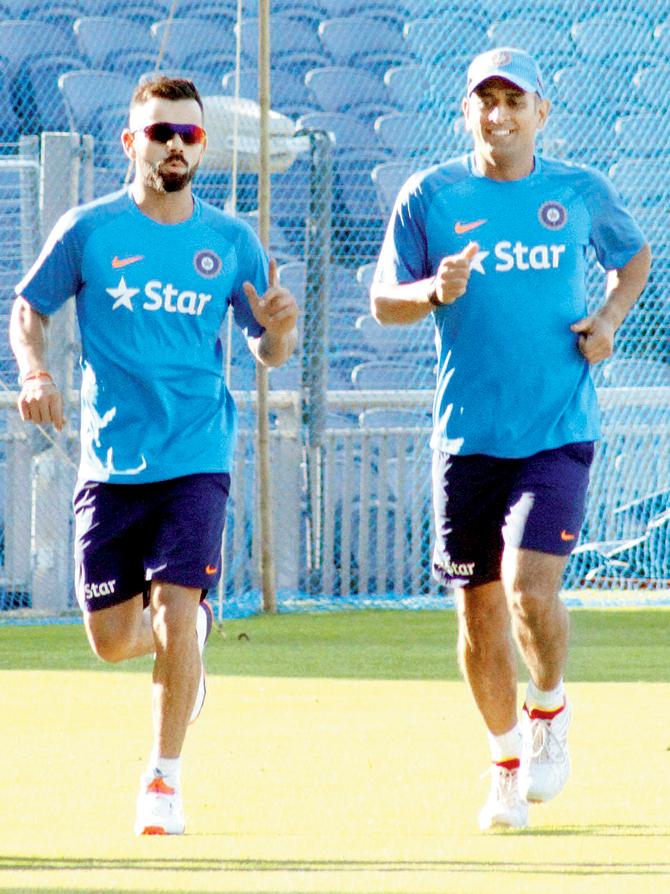 Team India skipper Virat Kohli (left) and MS Dhoni during a practice session in Pune yesterday. Pic/PTI