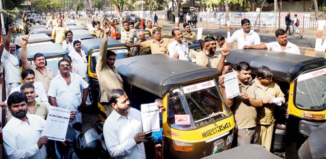 Members of the auto and taxi unions protest outside the Transport Commissioner’s office in Bandra (East). Pic/Nimesh Dave