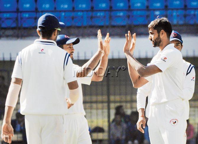 Gujarat pacer Chintan Gaja (right) celebrates a Mumbai wicket at Indore yesterday.