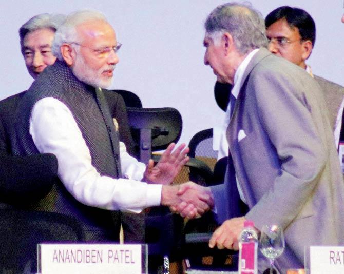 Prime Minister Narendra Modi shakes hands with Ratan Tata