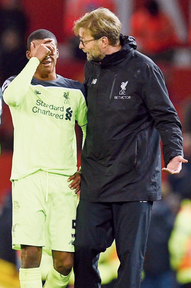 Liverpool boss Jurgen Klopp (right) consoles Georginio Wijnaldum after the EPL match against Man United on Sunday. Pic/AFP
