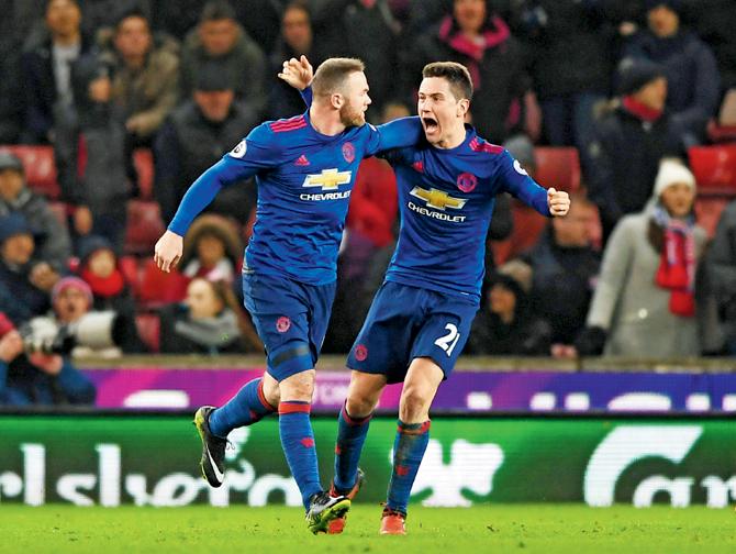 Man United’s Wayne Rooney (left) celebrates his goal with Ander Herrera during their EPL match vs Stoke on Saturday. Pic/AFP