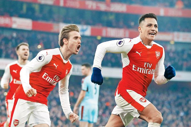 Arsenal’s Sanchez (right) celebrates his goal with Monreal during the EPL match vs Burnley in London yesterday. Pic/AFP