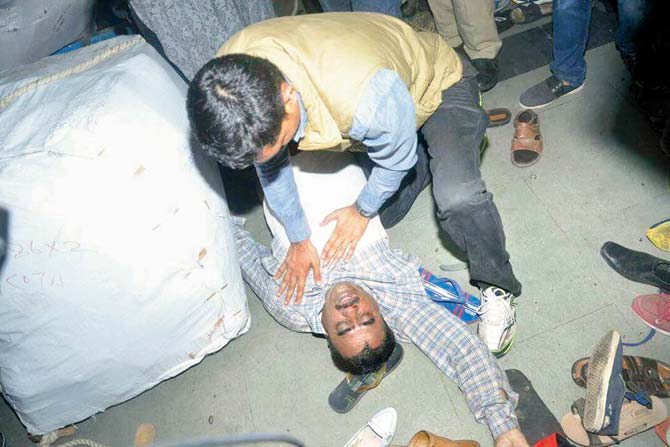 A medical staffer tries to resuscitate Farheed Khan Pathan