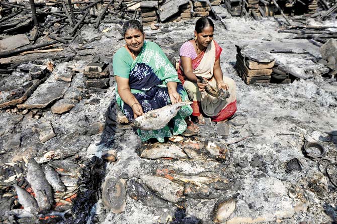 A woman shows the fish burnt during the protests