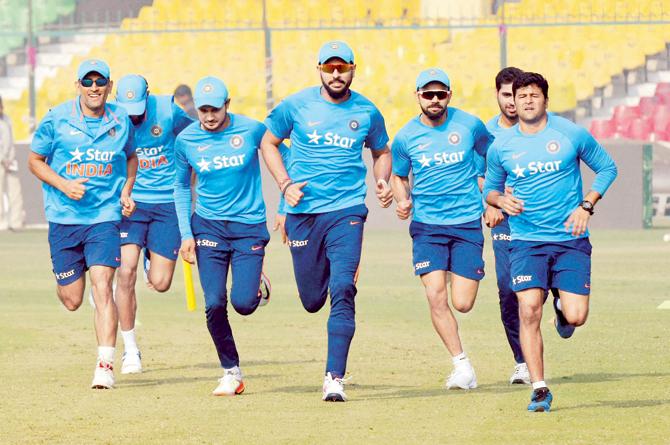 Yuvraj Singh (centre) leads MSâu00c2u0080u00c2u0088Dhoni, Hardik Pandya (looking down), Manish Pandey, Virat Kohli, Bhuvaneshwar Kumar and Rishabh Pant during a training session at Green Park, Kanpur yesterday. This is their first T20 series since August’s two-match contest vs WI in USA  Pic/PTI