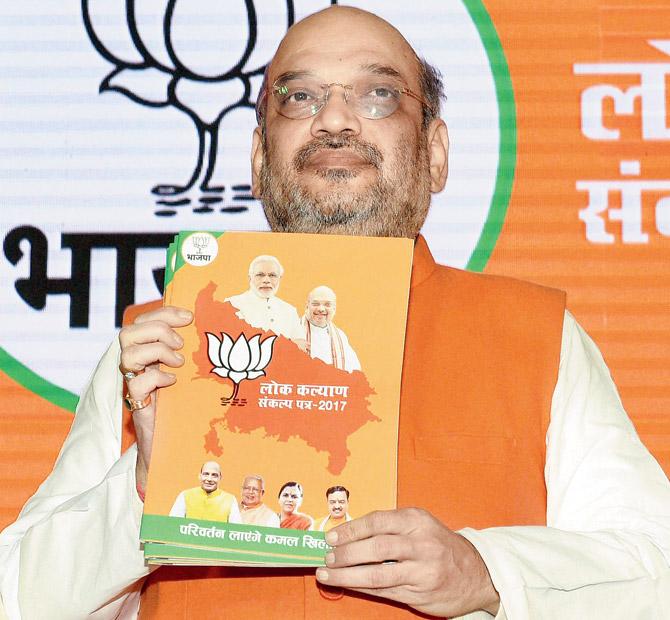Amit Shah releases the manifesto in Lucknow on Saturday. Pic/PTI