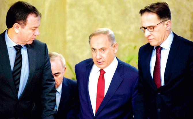 Israeli PMâu00c2u0080u00c2u0088Benjamin Netanyahu (centre) arrives at the weekly cabinet meeting. Pic/AP