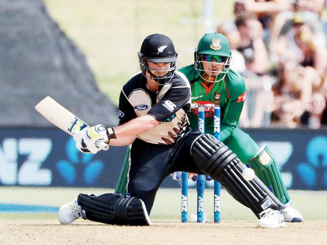 New Zealand’s Colin Munro plays a reverse sweep during the T20 encounter against Bangladesh yesterday. Pic/AFP