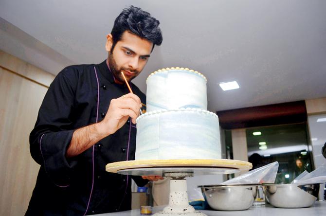 Chef Mohit Khilnani adds finishing touches to a Belgian chocolate geode cake at his Oshiwara outlet. Pic/Sneha Kaharabe