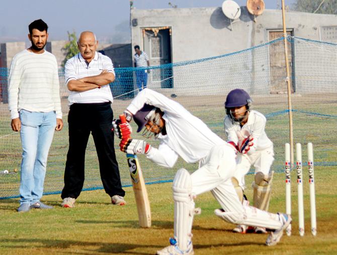 Cheteshwar and father Arvind Pujara watch a trainee perfect the forward defensive stroke at their academy. Pic/Bipin Tankaria