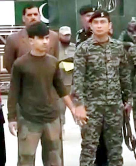 A video grab of Chavan (L) with Pakistan Army personnel on Saturday. Pic/Dawn