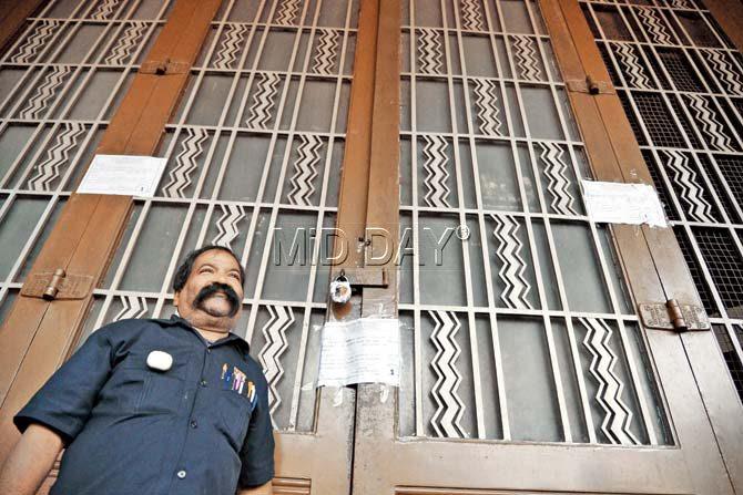 Watchman Dilip Adak outside the sealed theatre on Wednesday