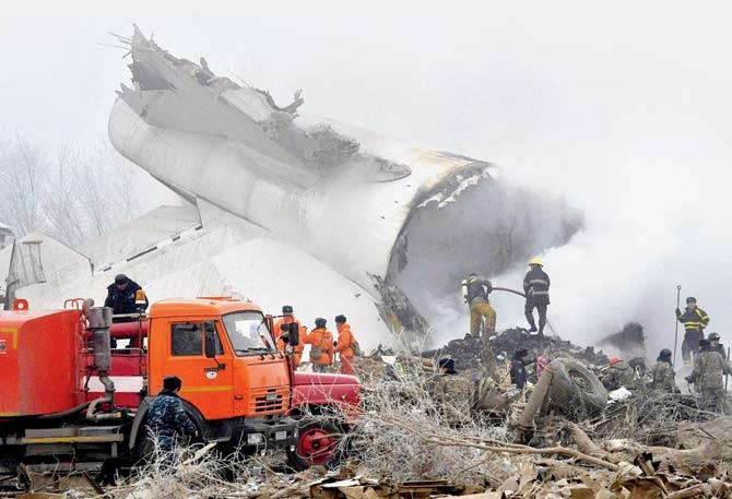 Kyrgyz Emergency Ministry officials and firefighters work among remains of a crashed Turkish Boeing 747 cargo plane at a residential area outside Bishkek, Kyrgyzstan, on Monday. Pic/AP