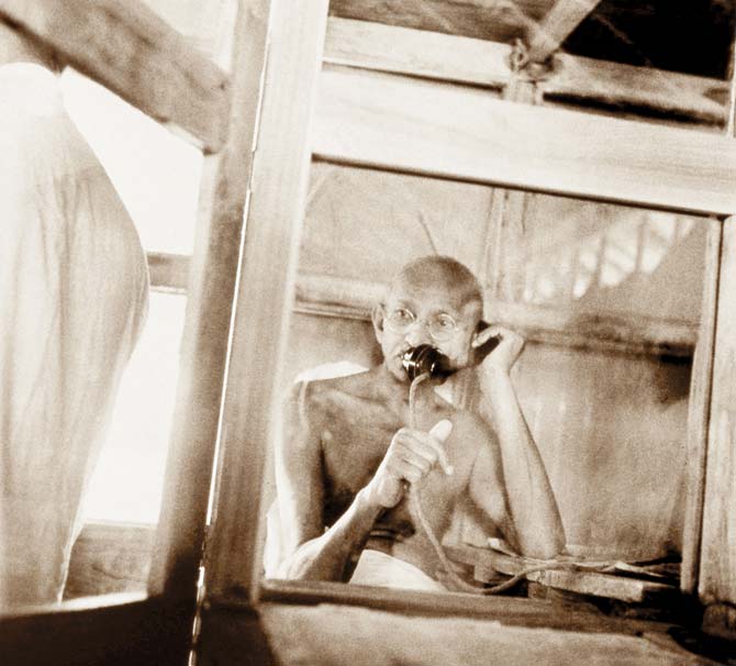Mahatma Gandhi telephoning from the office hut in Sevagram Ashram, 1938. Pics courtesy/ Kanu Gandhi, The Estate of Kanu Gandhi