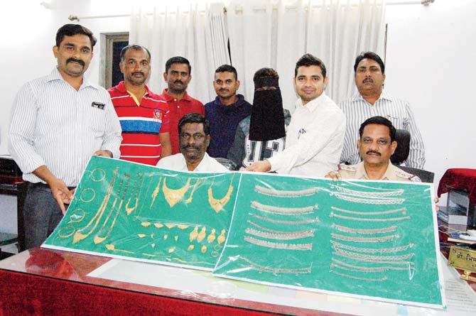 Police officers show the valuables recovered from the burglar who ransacked a home in Govandi