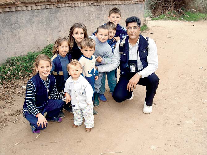 This is a photograph of Baijal during his stint in Kosovo. At the time, Baijal was on the Dancon March — a march-cum-run-cum-walk for 24 miles through rivers, valleys, mountains etc with a 10-kg bag on the back. Baijal had stopped to distribute chocolates to the children of the villages en route
