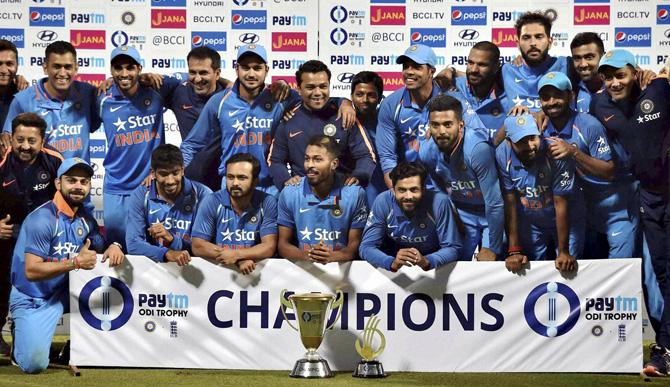 Indian team pose with trophy after winning the series after their third one day international cricket match against England at Eden Gardens in Kolkata on Sunday. Pic/PTI